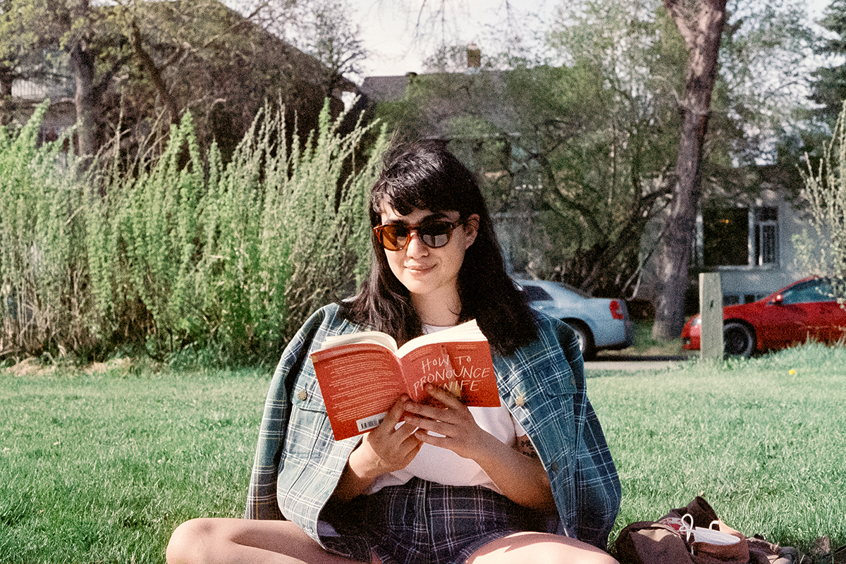 person reading book in park