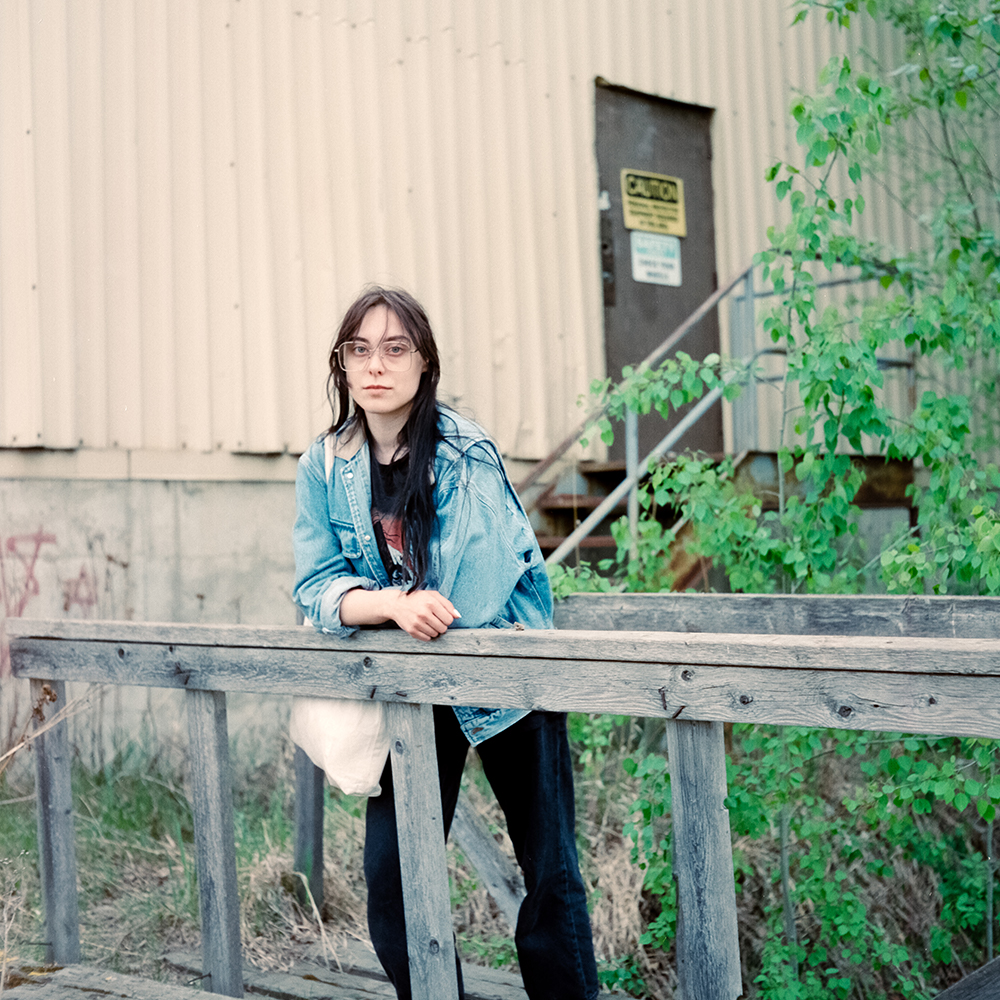 person leaning on fence