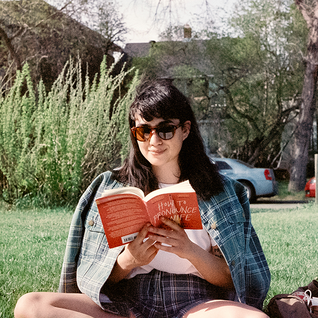 person reading book in park