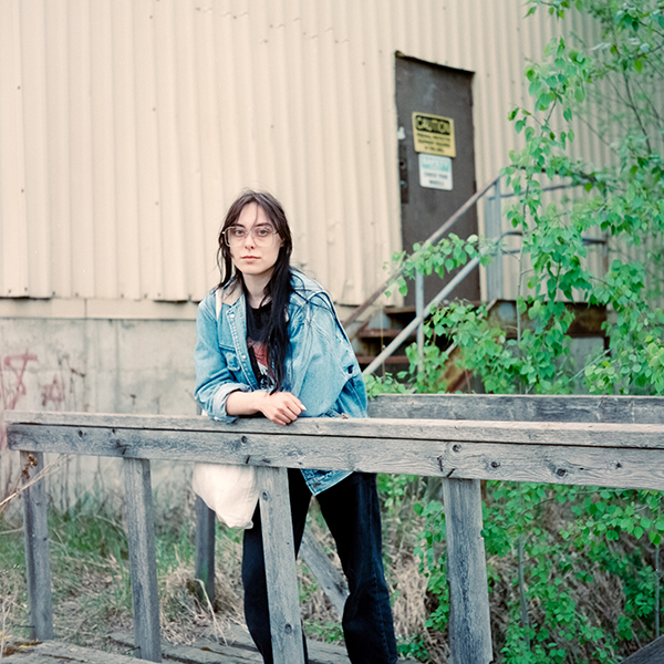 person leaning on fence