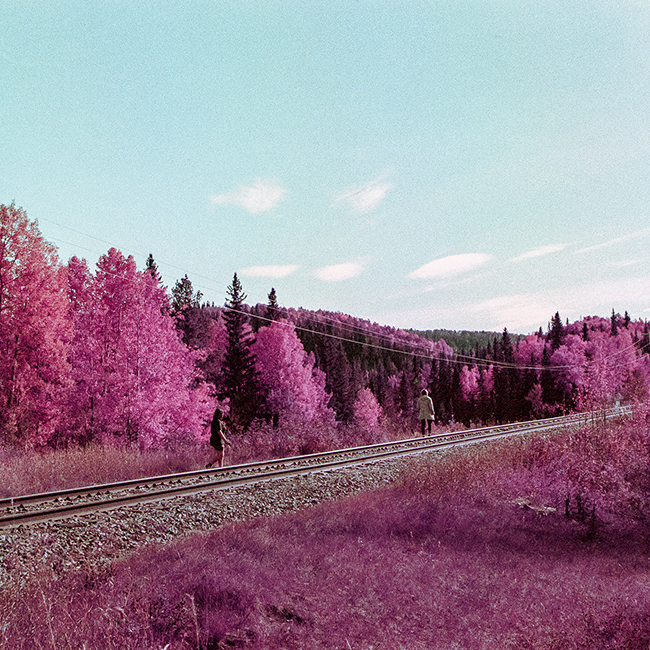 two people walking on railway track